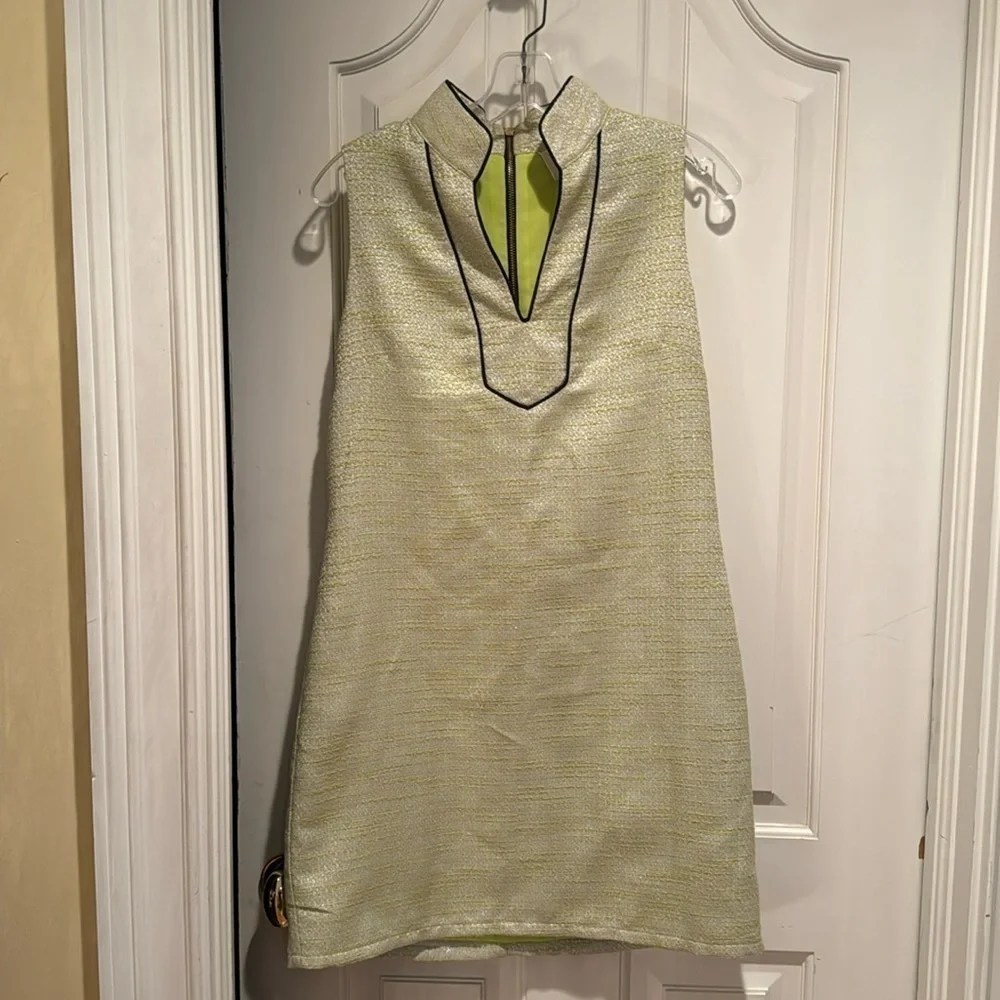 Sail to Sable green dress with silver white and black trim around neck